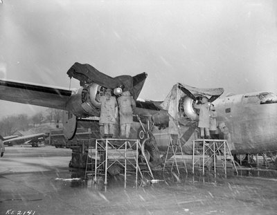 Through sleet and snow, Rockcliffe aircrew made sure the mail was delivered to the troops overseas, and back to families in Canada. Here they work on the engines of the mighty B24 at Rockcliffe.