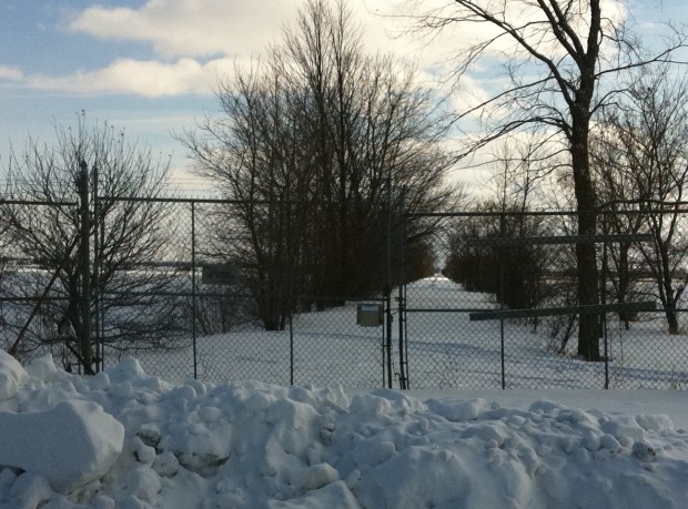 An abandoned road with a locked barbed wire encrusted gate sits north of Richmond, On.