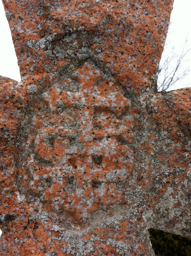 The symbol of "IHS" in the centre of the cross.