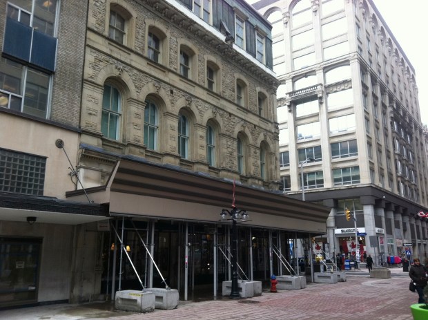 Dubbed "Canada's Four Corners Building", the structure has been covered with scaffolding for years. 