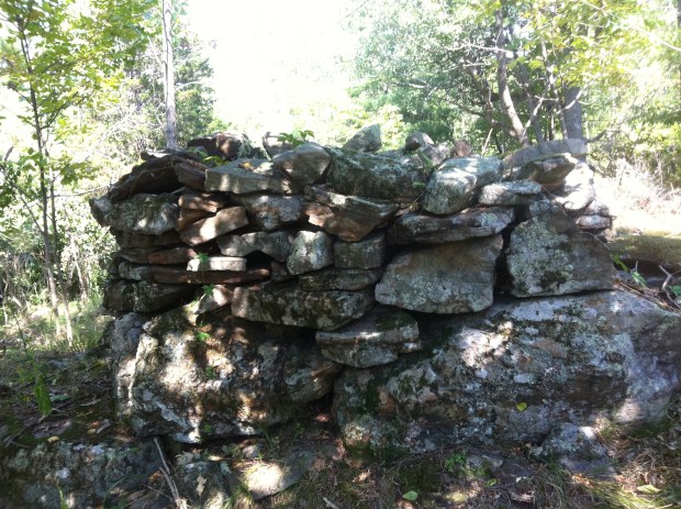 Rocks are piled neatly on top of existing ground boulders.