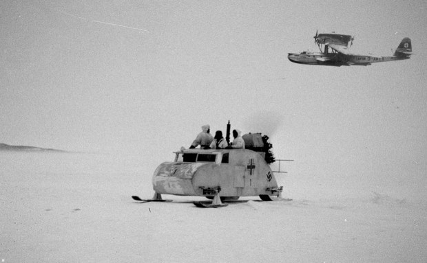 German tracked snow vehicle on patrol for Indiana Jones with a Dornier seaplane above. (Note: fictional composite photo)